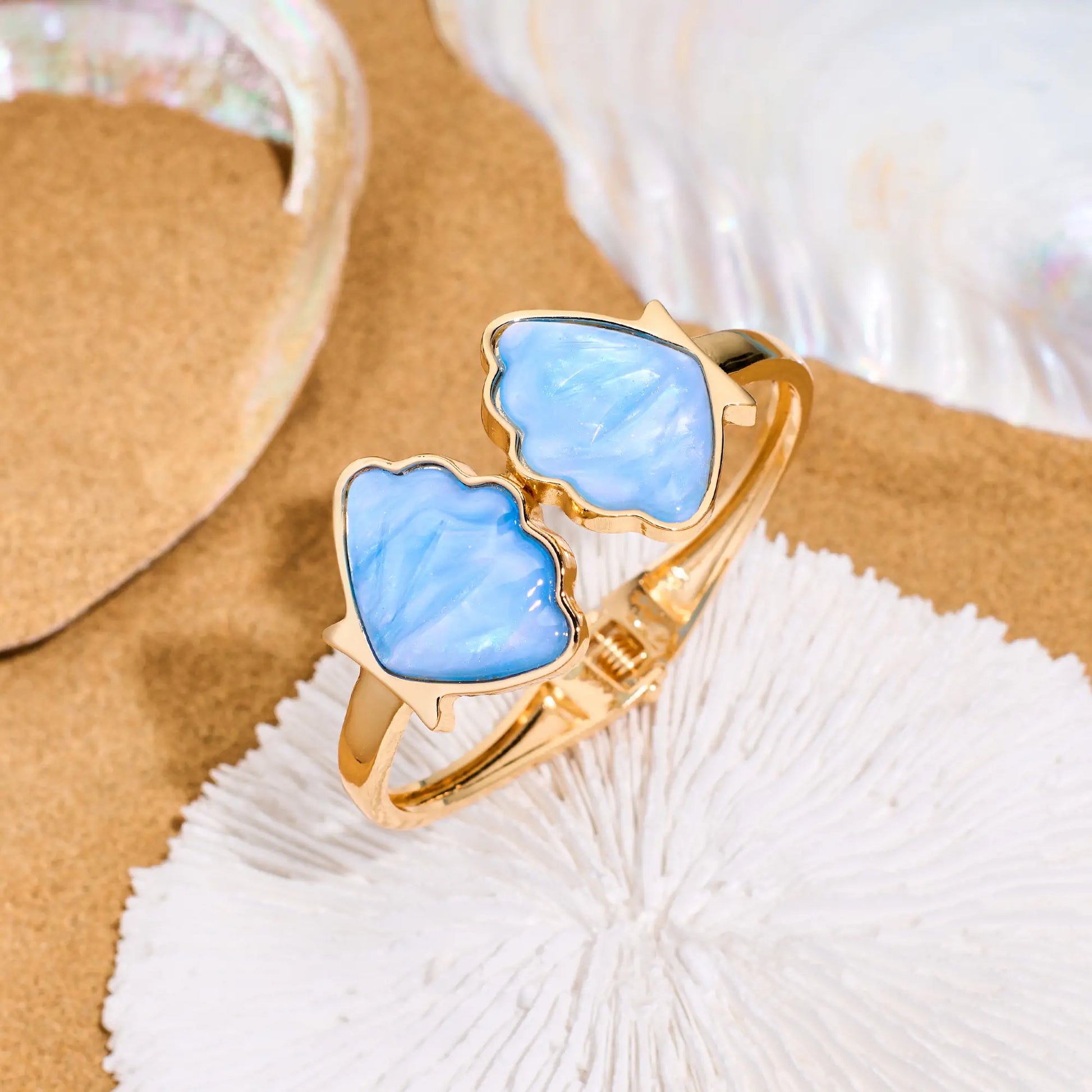 Flat lay of a seashell bracelet styled on sandy beach background – coastal summer jewelry