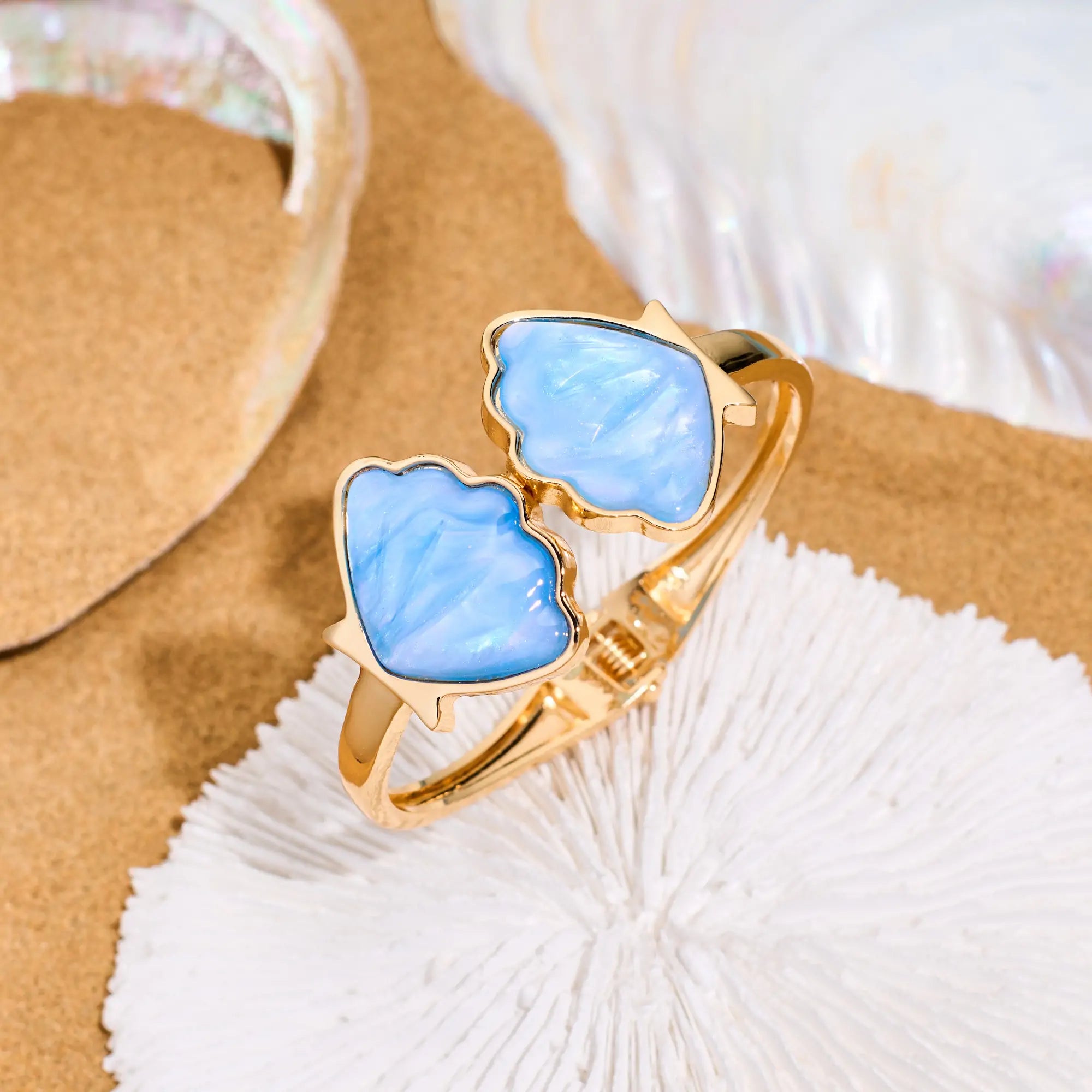 Flat lay of a seashell bracelet styled on sandy beach background – coastal summer jewelry
