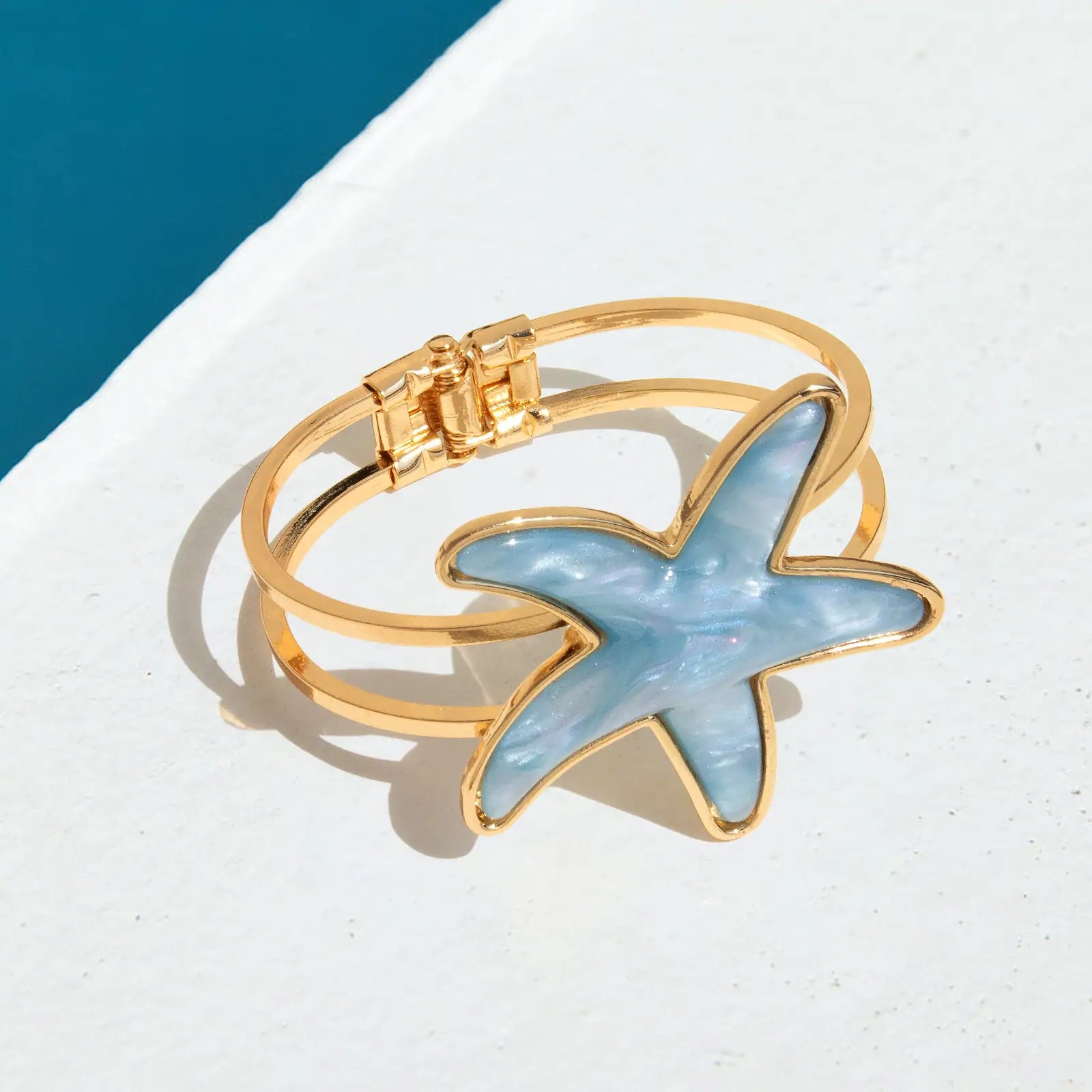 Blue acrylic starfish bracelet shown from side angle 