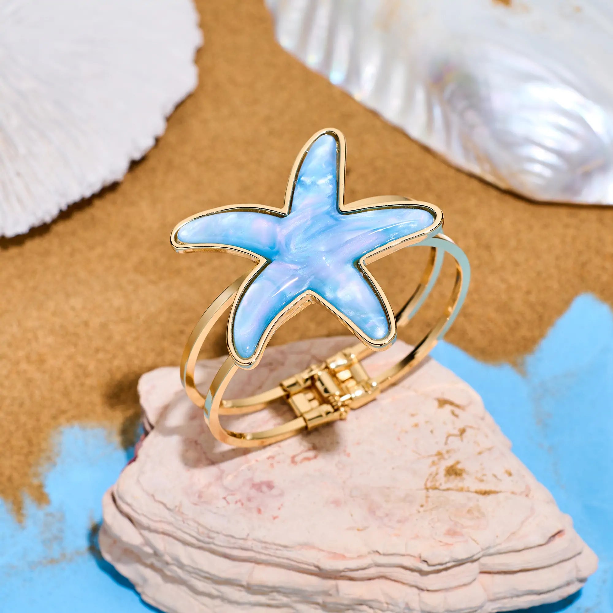 Top view of a bracelet on sandy beach – summer jewelry style